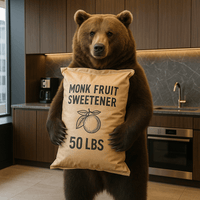 Bulk monk fruit sweetener 50 lbs bag held by a bear in a modern kitchen setting.