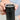 Close-up of a hand holding the GROSCHE TOKIO manual coffee grinder for travel with grind size adjustment.