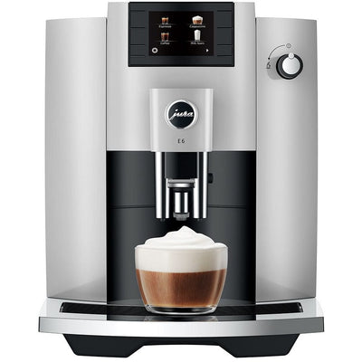 Jura E6 Espresso Machine with TFT display and cappuccino in a glass, showcasing fine foam technology.
